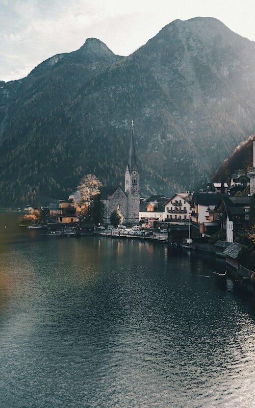 Scenic view of Hallstatt, Austria with mountains and a lakeside village, emphasizing Austrian landscapes.