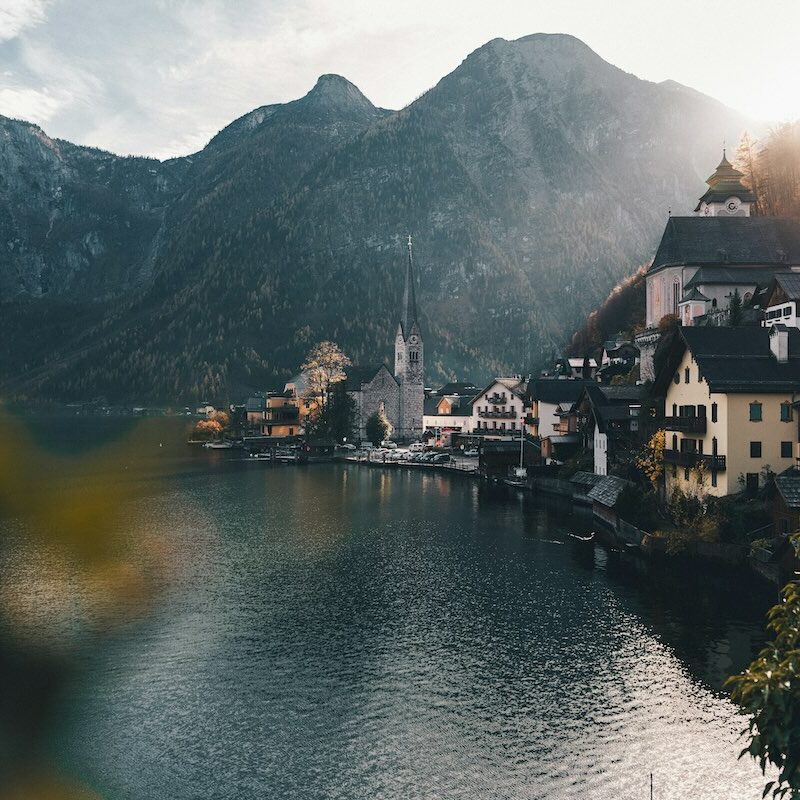 Scenic view of Hallstatt, Austria with mountains and a lakeside village, emphasizing Austrian landscapes.